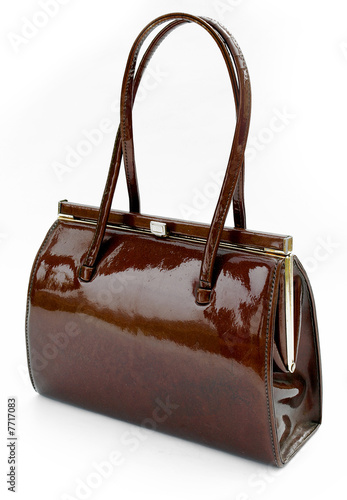 Brown leather handbag against a white background