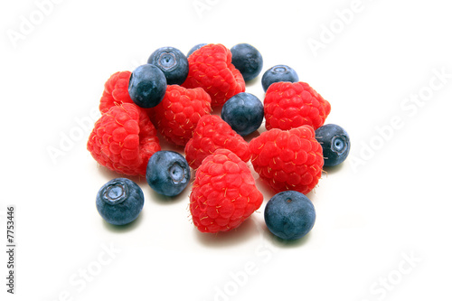 Raspberries and blueberries isolated on white