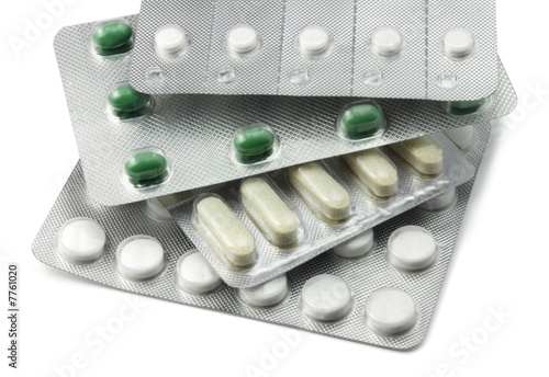 Stack of Various Foil Packaged Pills on White