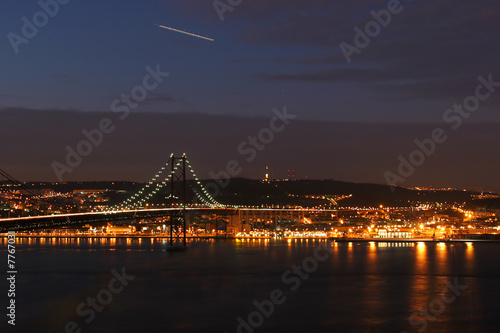 Lisbon Bridge with lisbon in background at night