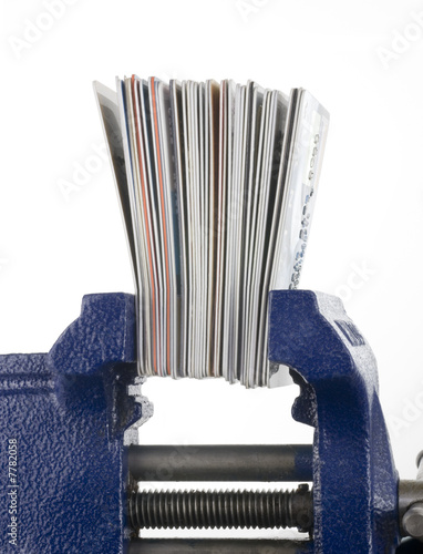 Credit Cards Squeezed in a Vise on White