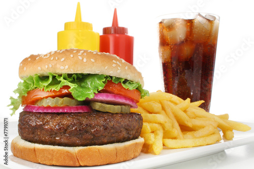 Hamburger meal served with french fries and soda close-up