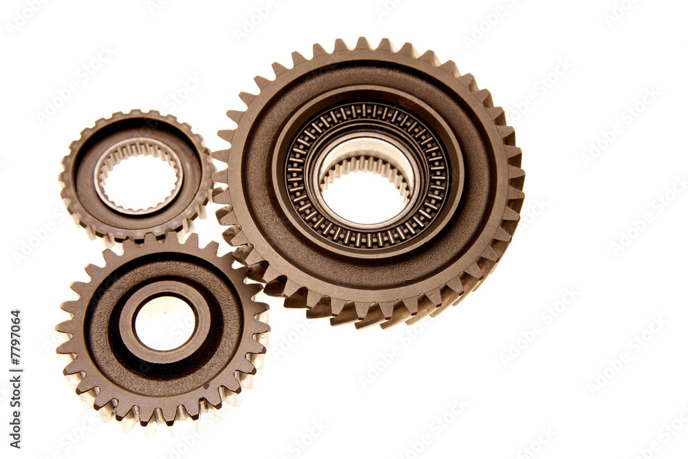 Three gears meshing together over white Three gears meshing together over white