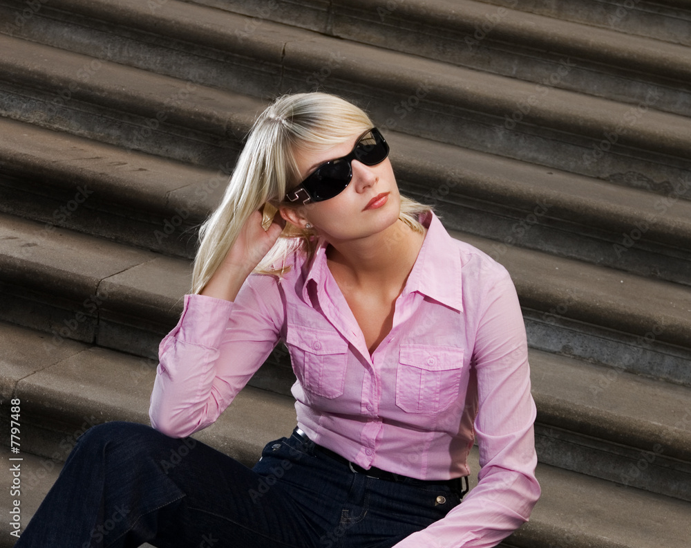 Beautiful young woman sitting on a stairs Beautiful young woman sitting on a stairs