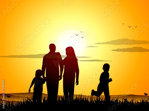 Happy family at sunset