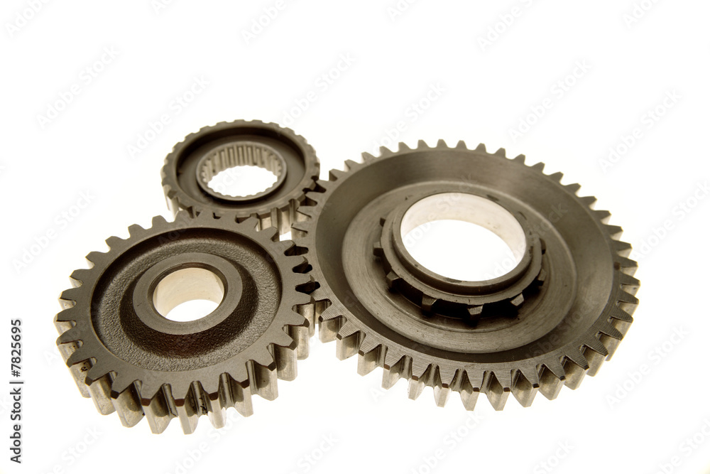 Three gears meshing together over white Three gears meshing together over white