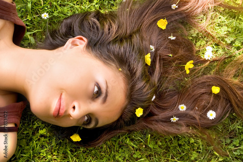Attractive Woman with Flowers in her hair lying down.