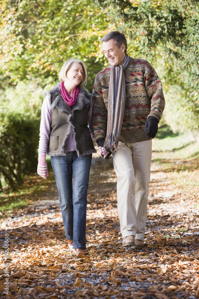 Fototapeta premium Senior couple walking along autumn path