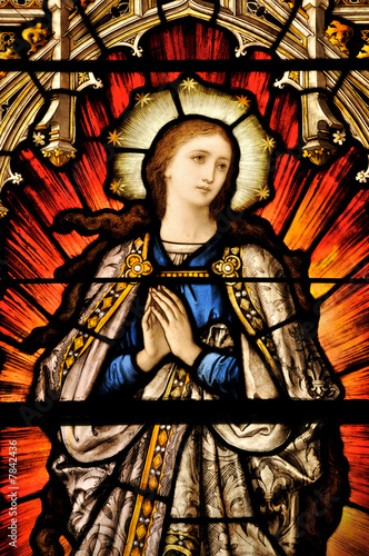 Stained Glass window of St Mary in contemplative prayer