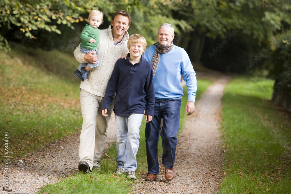 Grandfather walking with son and grandson Grandfather walking with son and grandson