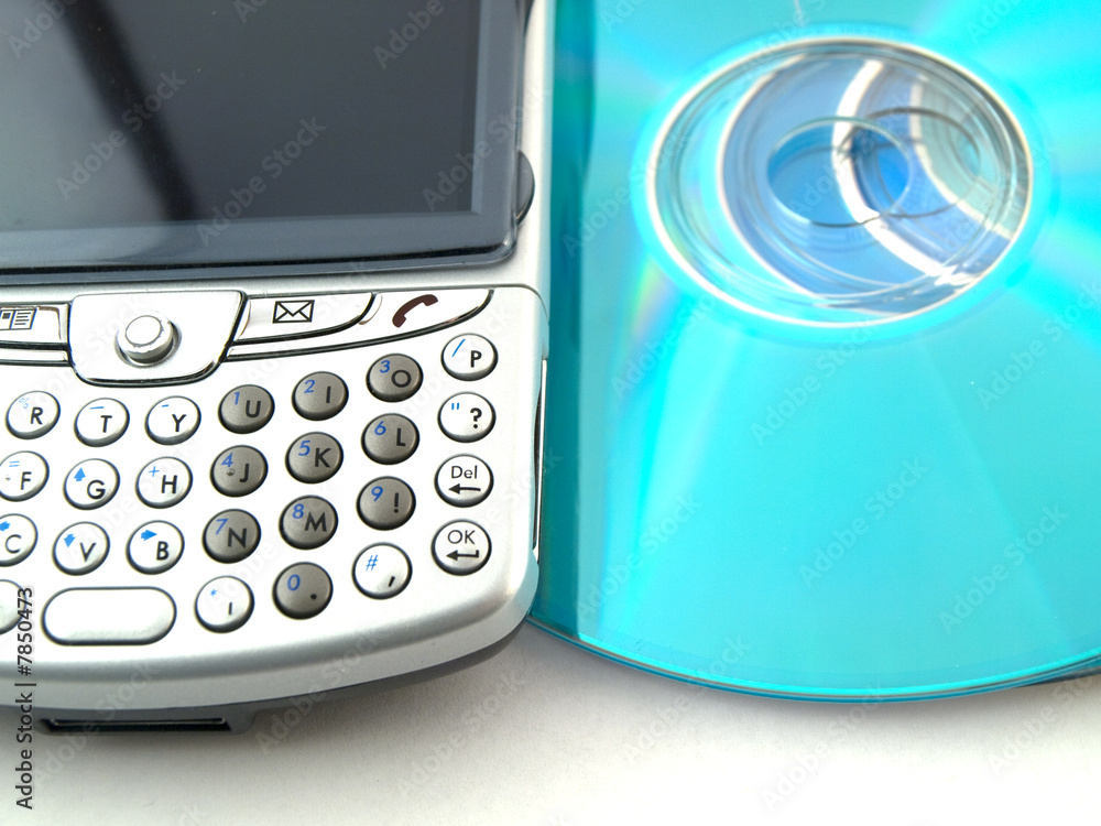 Fototapeta premium CDs DVDs and Mobile Phone PDA on White Background