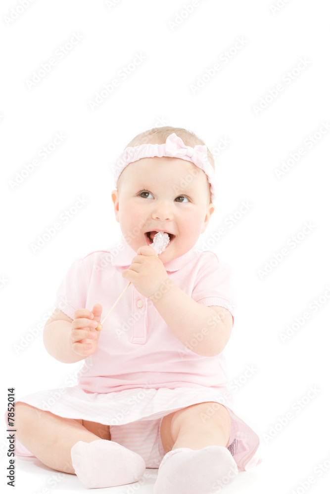 Sweet little girl tasting candy on stick isolated on white Sweet little girl tasting candy on stick isolated on white