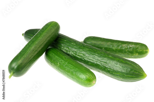 Four cucumbers on white.