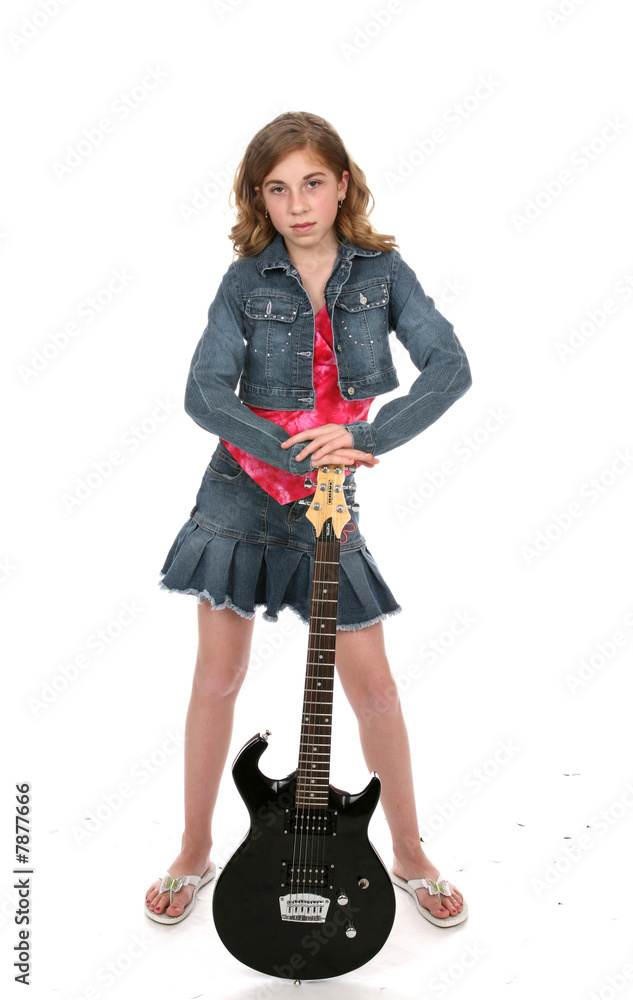 Cute girl wearing denim and leaning on a black electric guitar. Cute girl wearing denim and leaning on a black electric guitar.