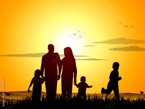 Happy family at sunset