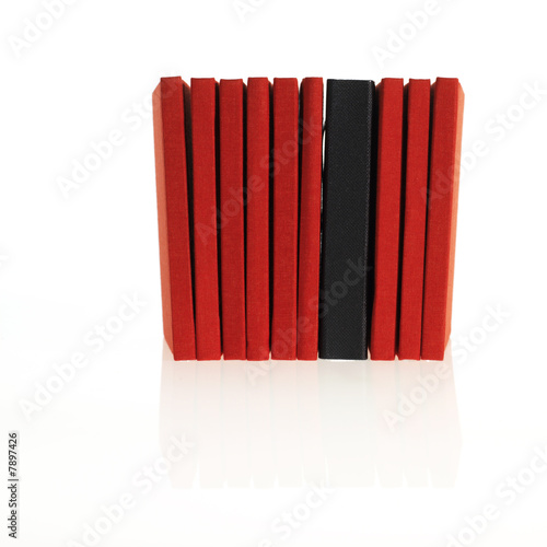 a lot of red books with a black one in between