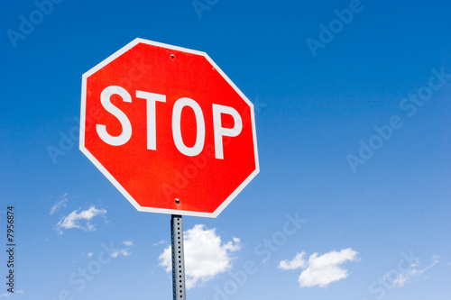 Stop sign against blue sky