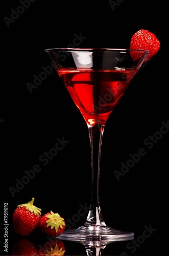 Red cocktail with strawberries on black background