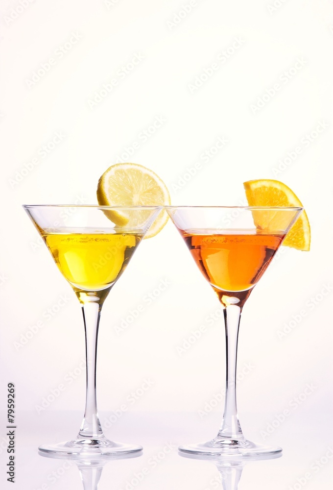 Two colorful cocktails with fruits on white background