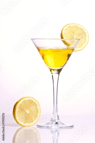 Yellow cocktail with lemon on white background