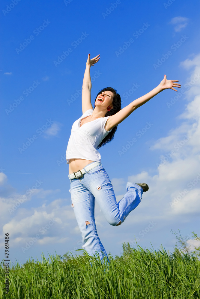 expressive woman dancing on green grass