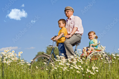 Riding with grandpa on a bike © Ilike