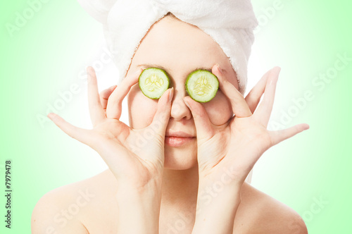 Woman with cucumbers on eyes