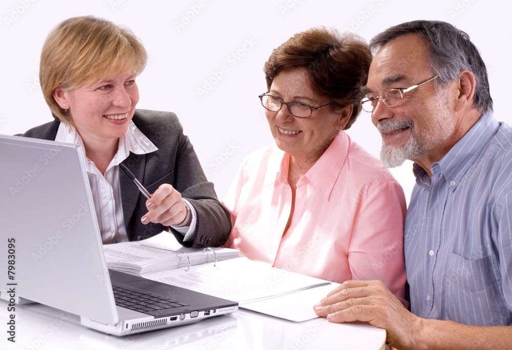 Mature couple talking to financial planner at home Mature couple talking to financial planner at home