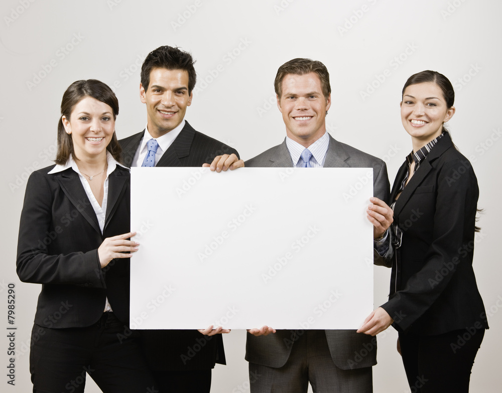 Business people holding blank poster board Business people holding blank poster board