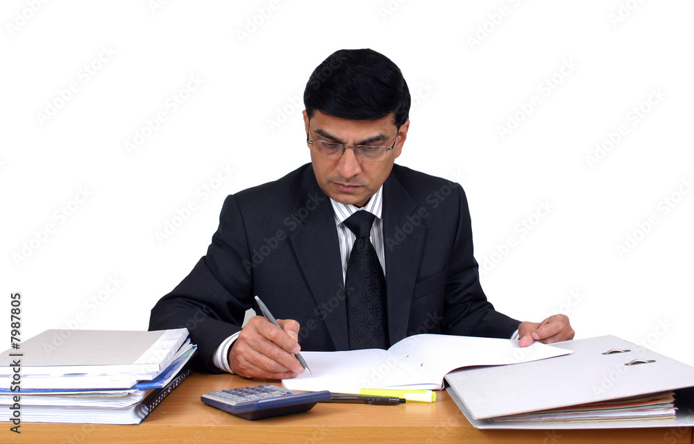 Indian business man working at his desk (Series) Indian business man working at his desk (Series)
