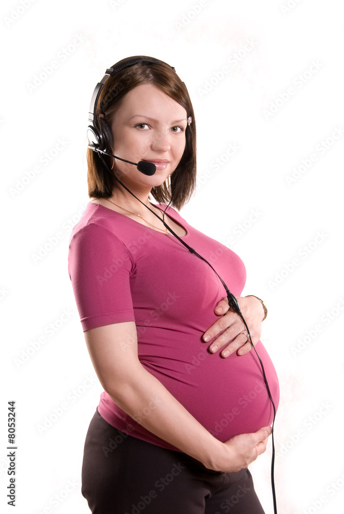 Pregnant woman wearing earphones with a microphone Pregnant woman wearing earphones with a microphone