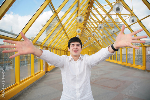 young asian man shows salutatory gesture photo