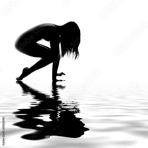 Asian model stretching by the water