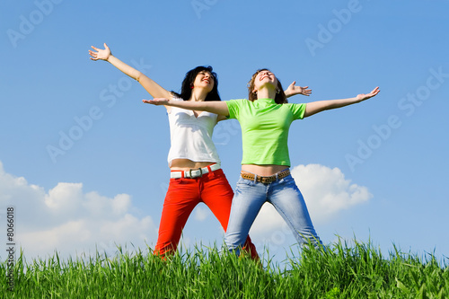 two happy young women dreams to fly on winds