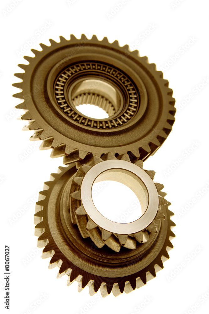 Two gears meshing together over white Two gears meshing together over white