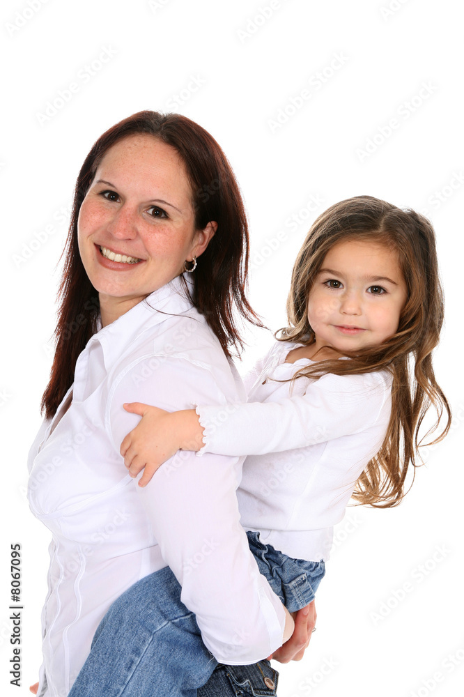 Attractive mother giving her little girl a piggy back ride. Attractive mother giving her little girl a piggy back ride.