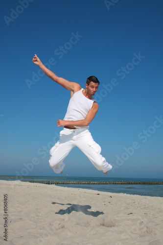 white dressed jumping men on the sea
