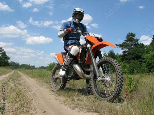 Fototapeta Naklejka Na Ścianę i Meble -  raider sitting on the motocross bike