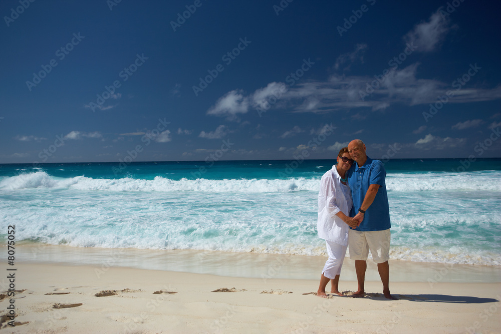senior couple at sandy beach