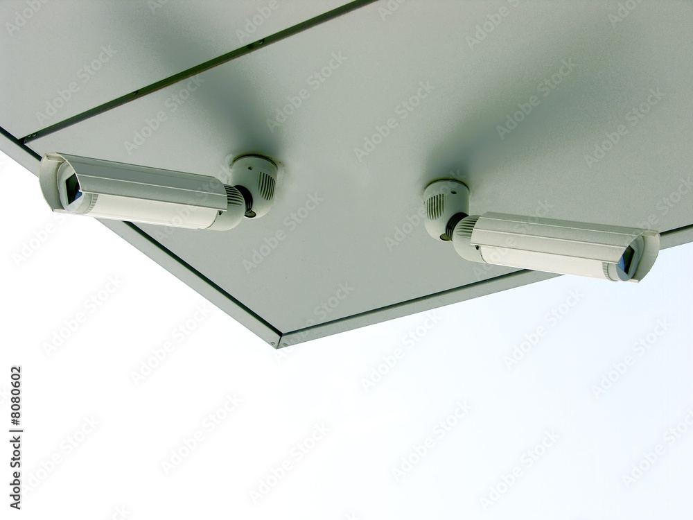 Two white security cameras
