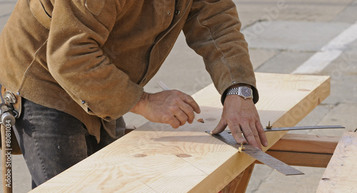 Carpenter marking out steps on a stringer photo