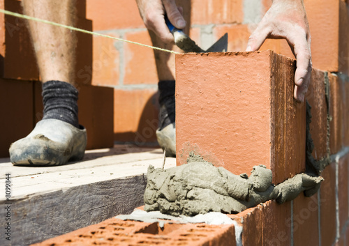 construction worker building a wall