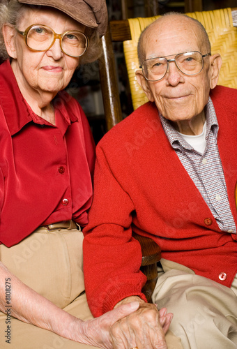 Senior Man and Woman Sitting Together Holding Hands.  Pleasant .