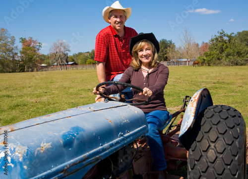 Mature Farm Couple on Tractor