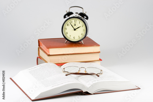Alarm clock, book and eyeglasses