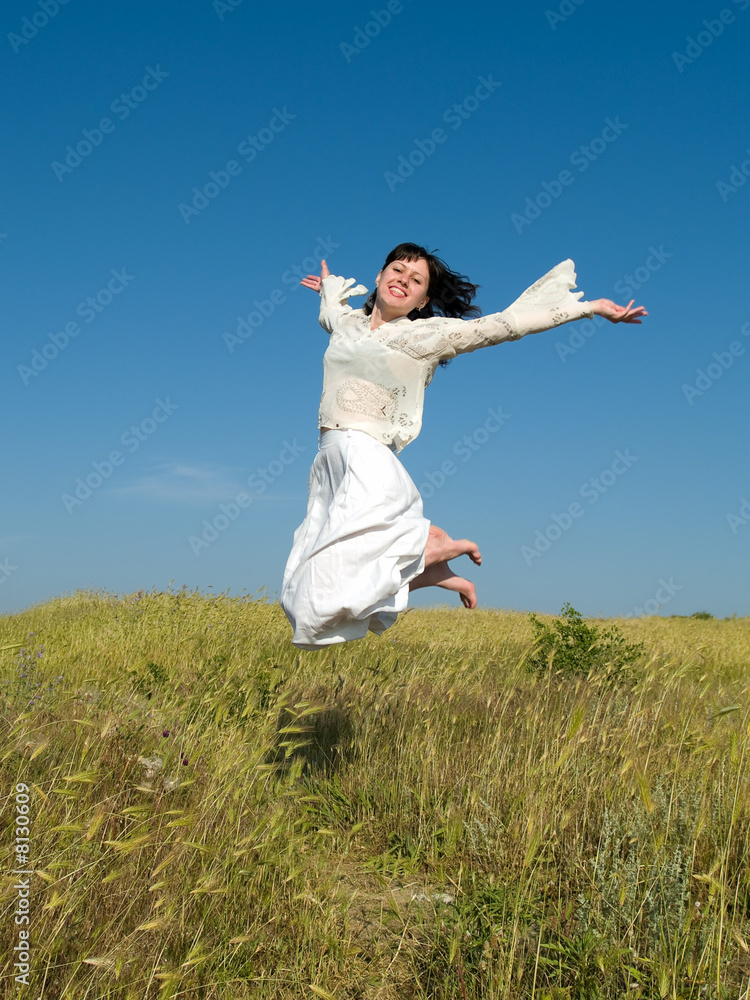 Happy Jumping Girl above Field