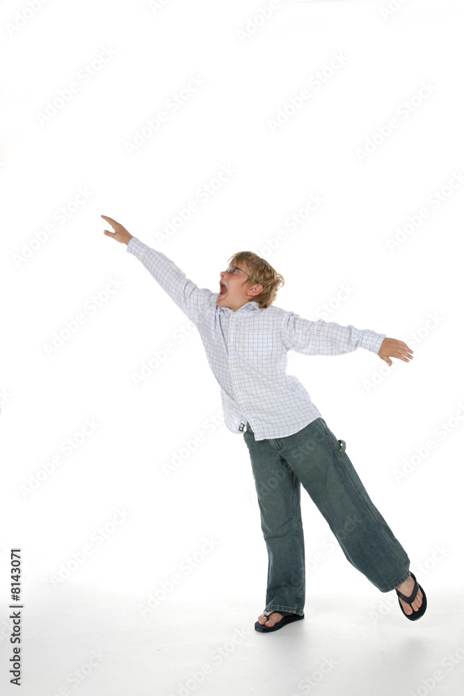 young boy with arms outstretched as if flying and balancing young boy with arms outstretched as if flying and balancing