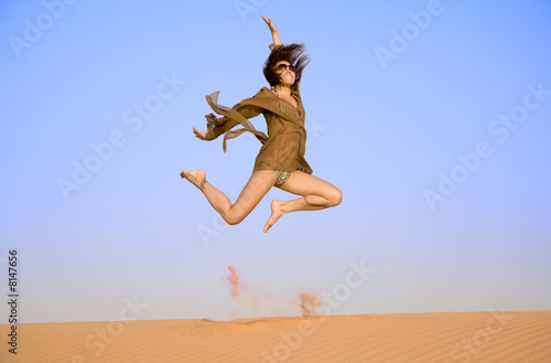 Jumping girl on the sand 