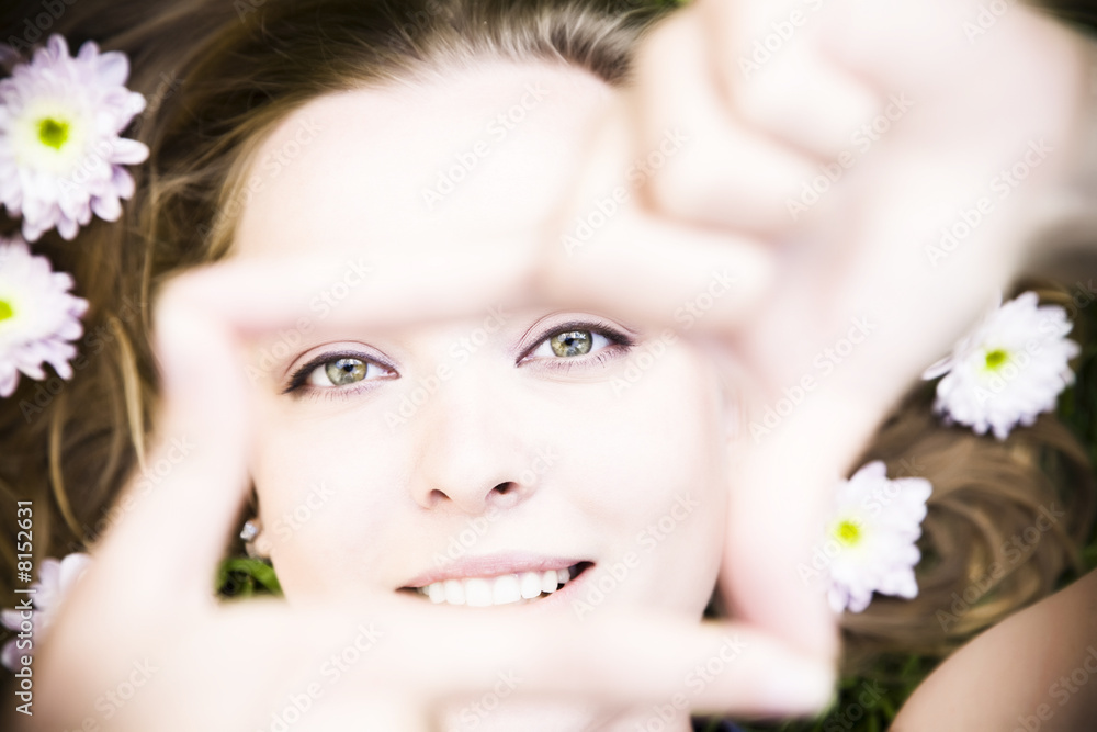 Portrait of young woman creates a frame with her hands Portrait of young woman creates a frame with her hands
