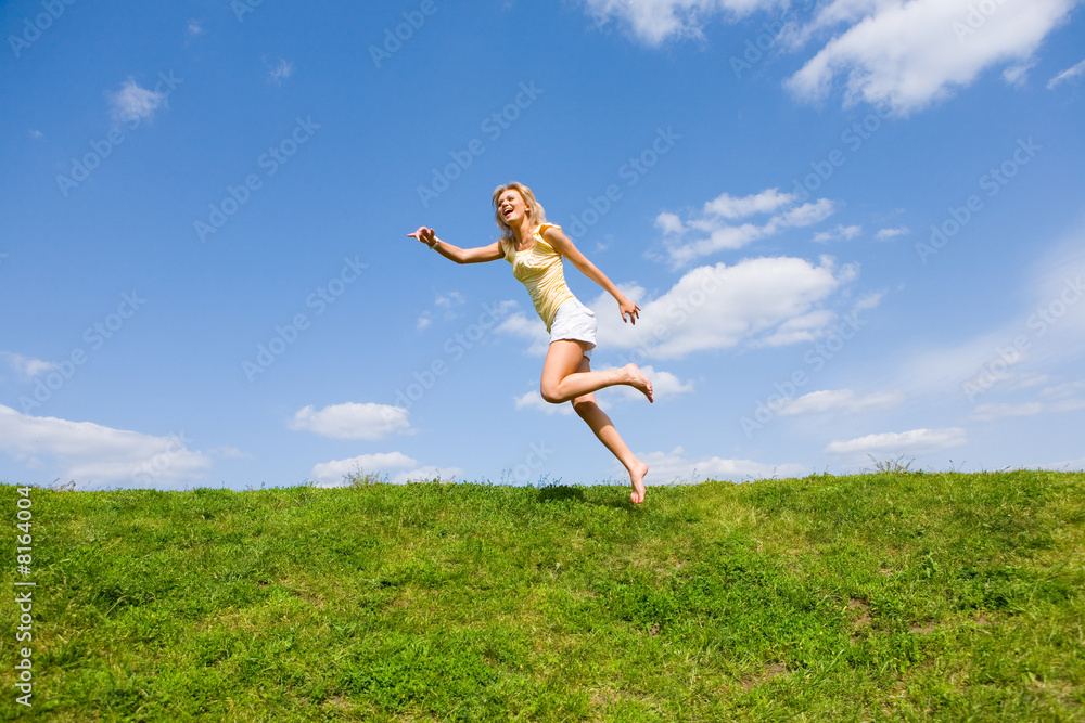 Happy young woman is running in a field Happy young woman is running in a field